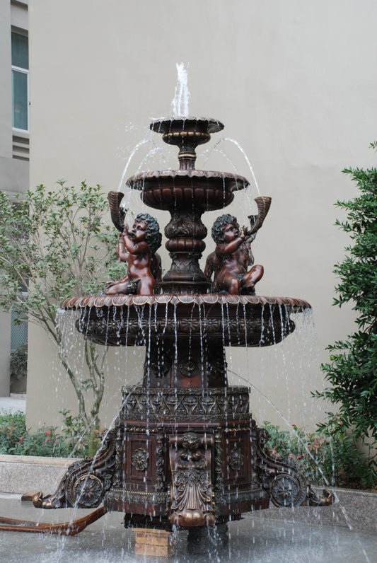 Large bronze cherub garden fountain with four angel figures and tiered water basins