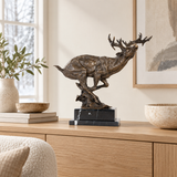 Leaping Reindeer bronze sculpture displayed in a minimalist interior