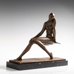 Front three-quarter view of seated bronze woman with one hand beside her face and legs extended