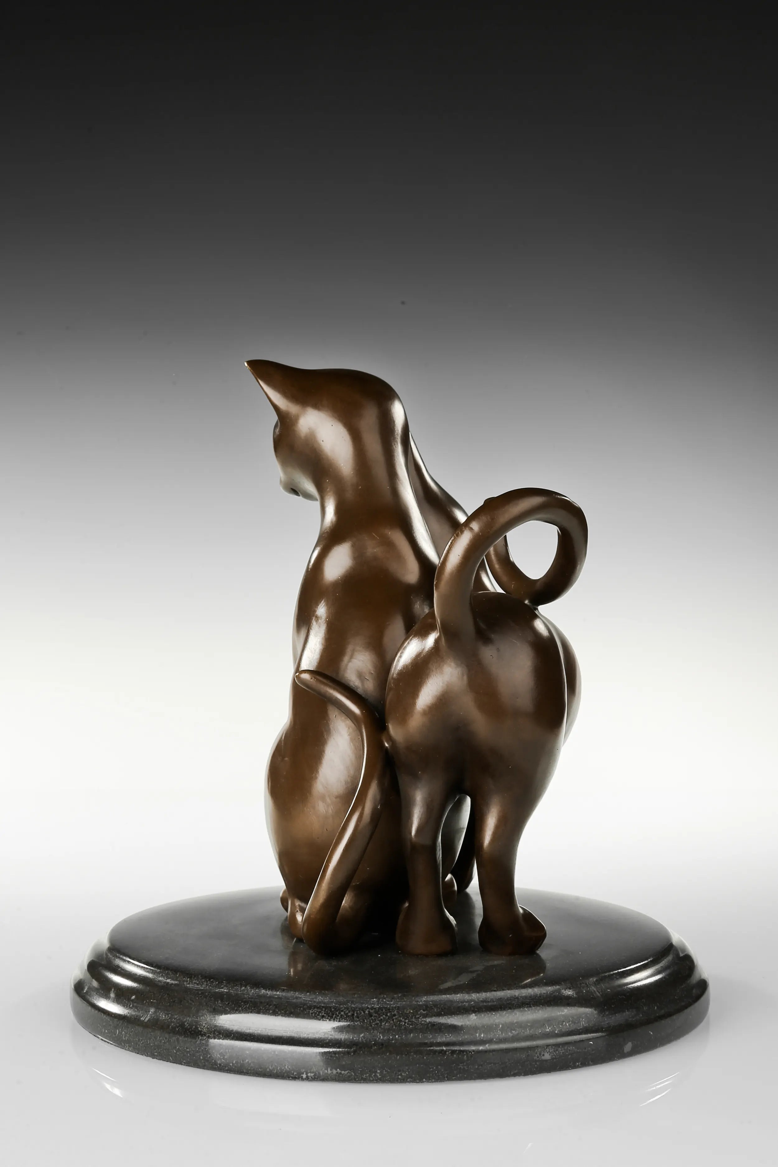 Three-quarter view of loving cats bronze sculpture on a dark marble base