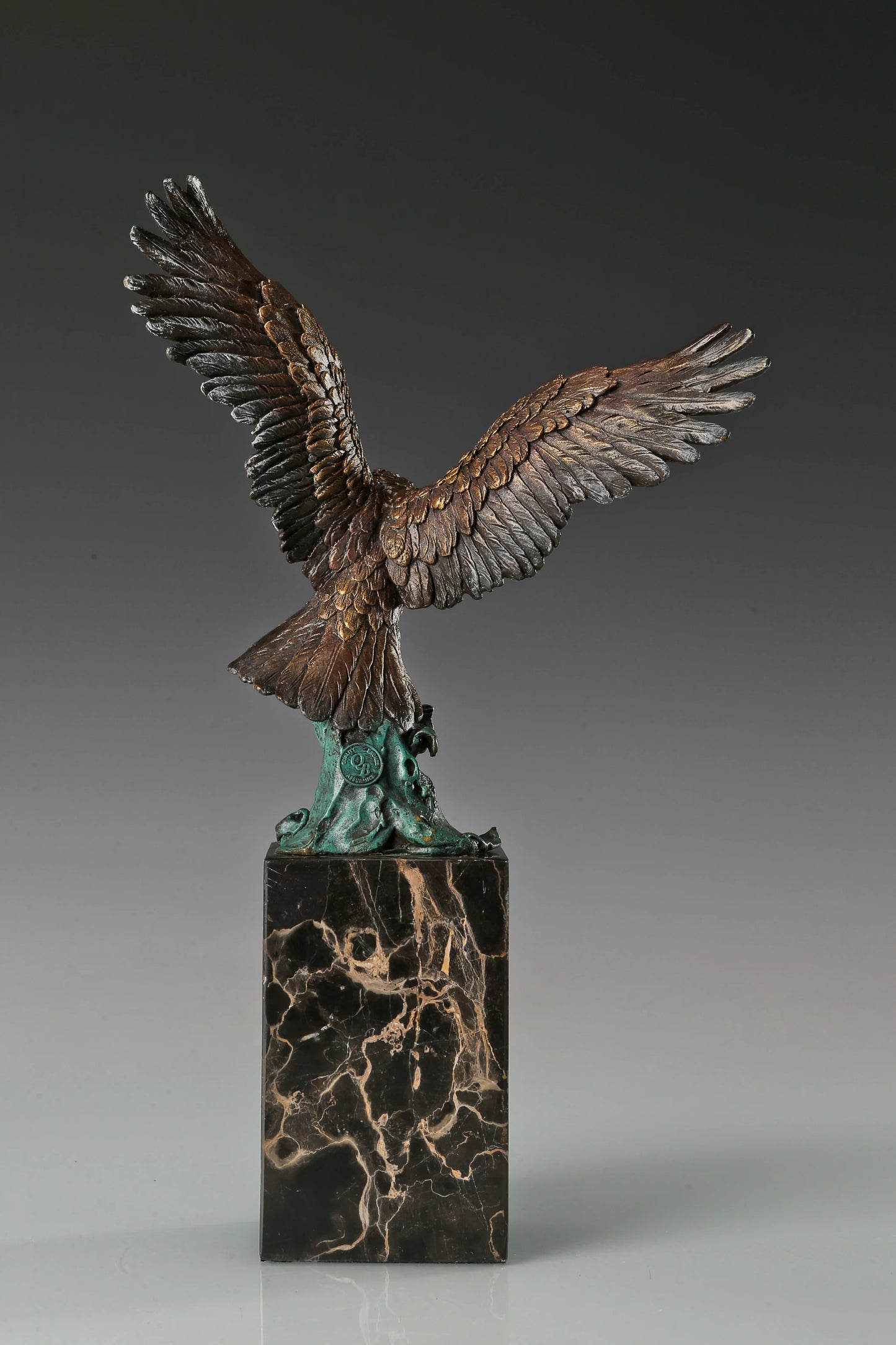 Handcrafted bronze eagle sculpture featuring spread wings and detailed feathers. Mounted on a marble base, this striking wildlife statue symbolizes strength, freedom, and prestige.