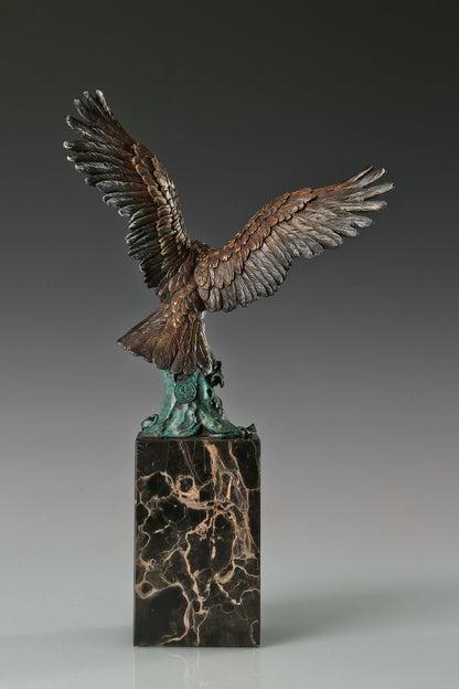 Handcrafted bronze eagle sculpture featuring spread wings and detailed feathers. Mounted on a marble base, this striking wildlife statue symbolizes strength, freedom, and prestige.