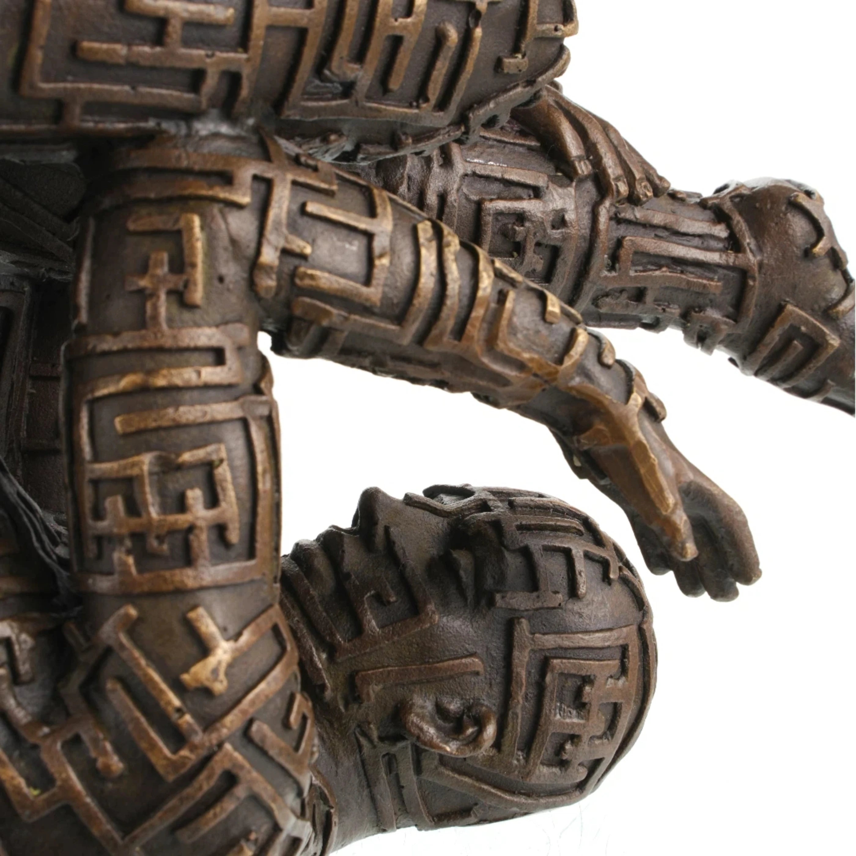 Maze pattern detail on bronze human sculpture