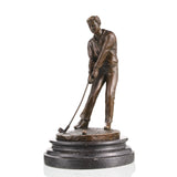 Hyper-realistic bronze golfer sculpture mid-putt, detailed man putting golf ball statue on stepped black marble base, loss wax casting sports art for office decor.