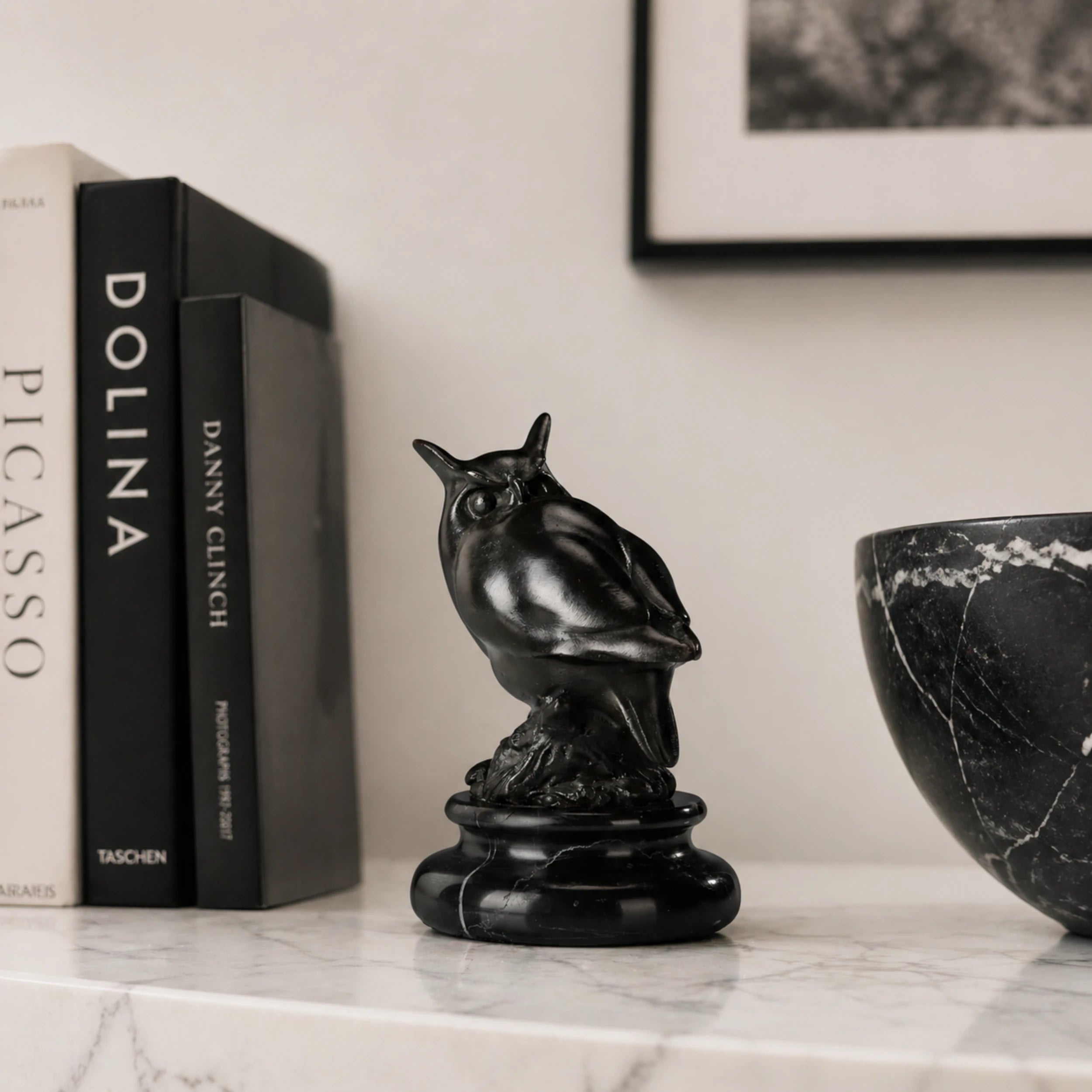 a modern abstract bronze owl sculpture with smooth minimalist lines and a black marble base. A stylish symbol of wisdom, perfect for contemporary home or office decor.