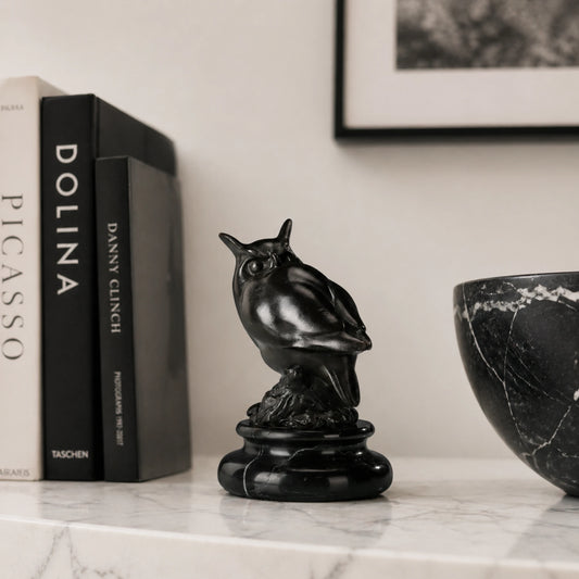 a modern abstract bronze owl sculpture with smooth minimalist lines and a black marble base. A stylish symbol of wisdom, perfect for contemporary home or office decor.