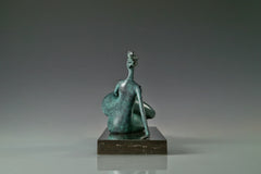 Reverse side of modern reclining woman bronze statue with extended legs