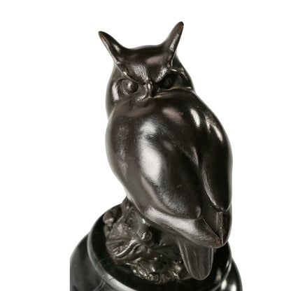 a modern abstract bronze owl sculpture with smooth minimalist lines and a black marble base. A stylish symbol of wisdom, perfect for contemporary home or office decor.