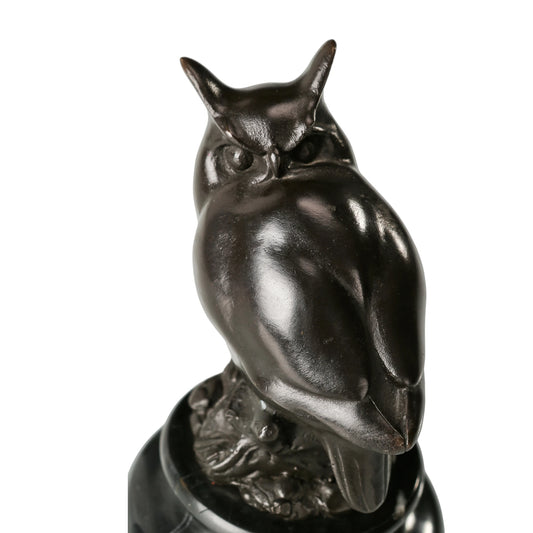 a modern abstract bronze owl sculpture with smooth minimalist lines and a black marble base. A stylish symbol of wisdom, perfect for contemporary home or office decor.