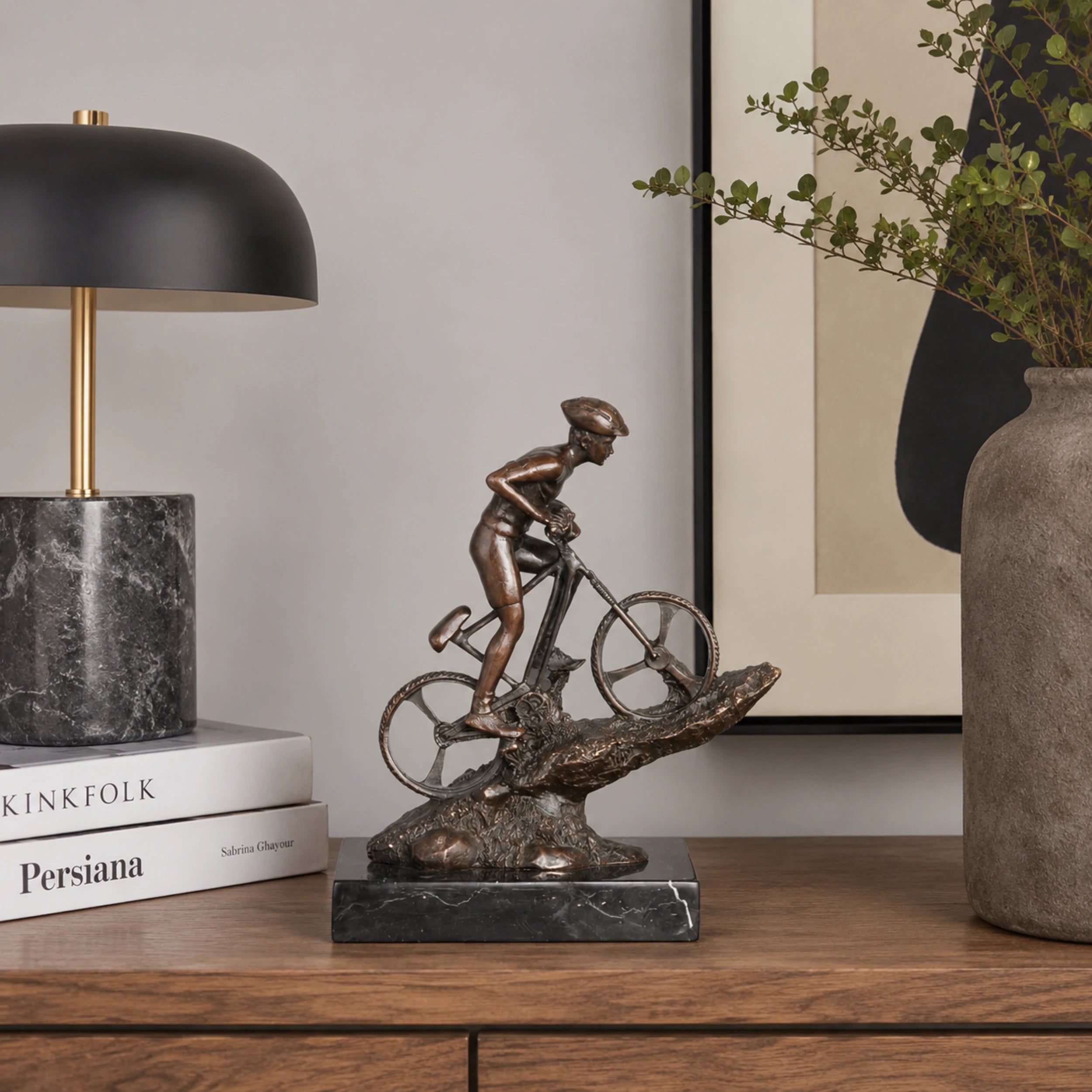 Mountain Biker Bronze Sculpture displayed in a modern interior