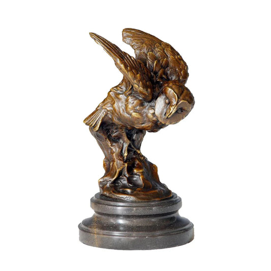 A bronze owl statue capturing the powerful moment of flight. Detailed feather textures and a black marble base make this wildlife statue perfect for home or office decor.
