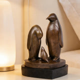This penguin family bronze sculpture captures a tender moment between three penguins, rendered in clean, minimalist lines that emphasize form, balance, and emotional connection. Expertly crafted from solid bronze, the sculpture features a warm, natural finish that enhances its timeless character and tactile appeal. 