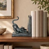 Playful Cat Bookend I bronze sculpture displayed in a minimalist interior