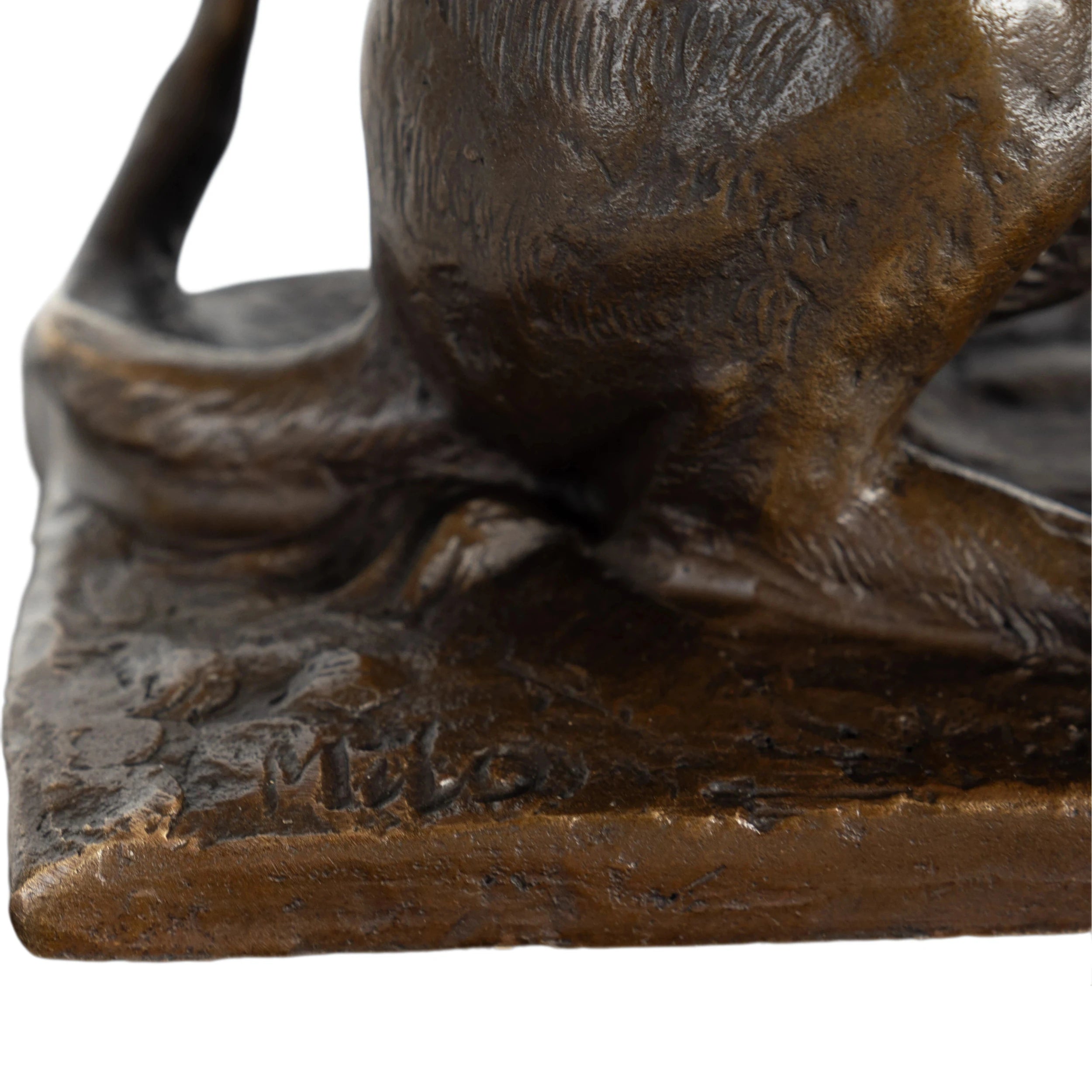 base of playful bronze cat statue with extended paw and butterfly detail
