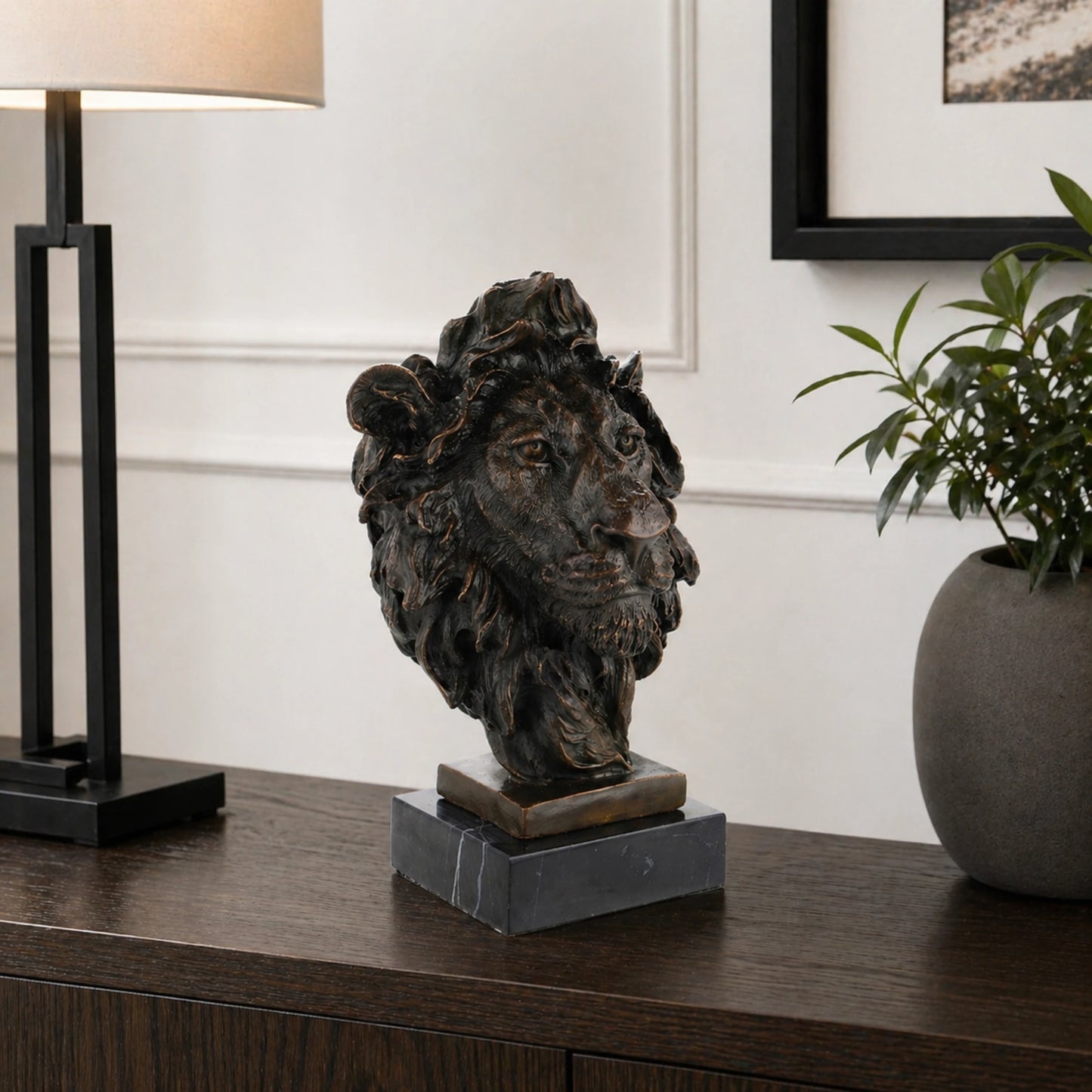 This powerful bronze lion bust is crafted using the traditional lost-wax casting method, capturing the animal’s head and upper neck with remarkable realism. The rich bronze patina highlights the lion’s piercing gaze, detailed whiskers, and dynamic, wind-swept mane, conveying strength and regal authority. The sculpture is mounted on a solid bronze block and dark marble plinth, enhancing its stability and grand presence.
