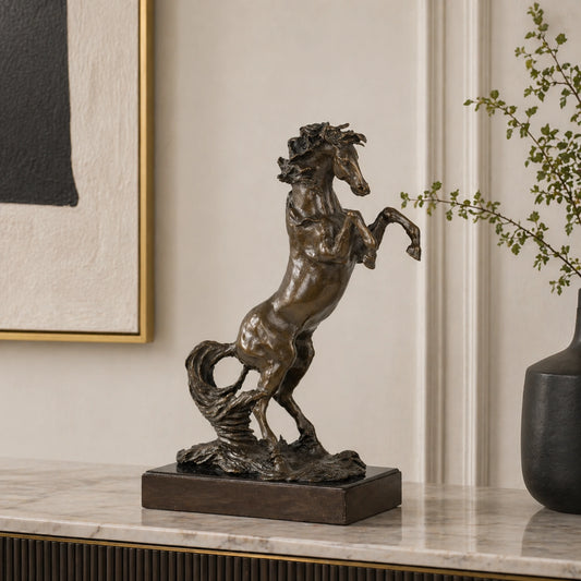 powerful rearing bronze horse statue with raised front legs and flowing mane, realistic stallion statue on black marble base, loss wax casting fine art.