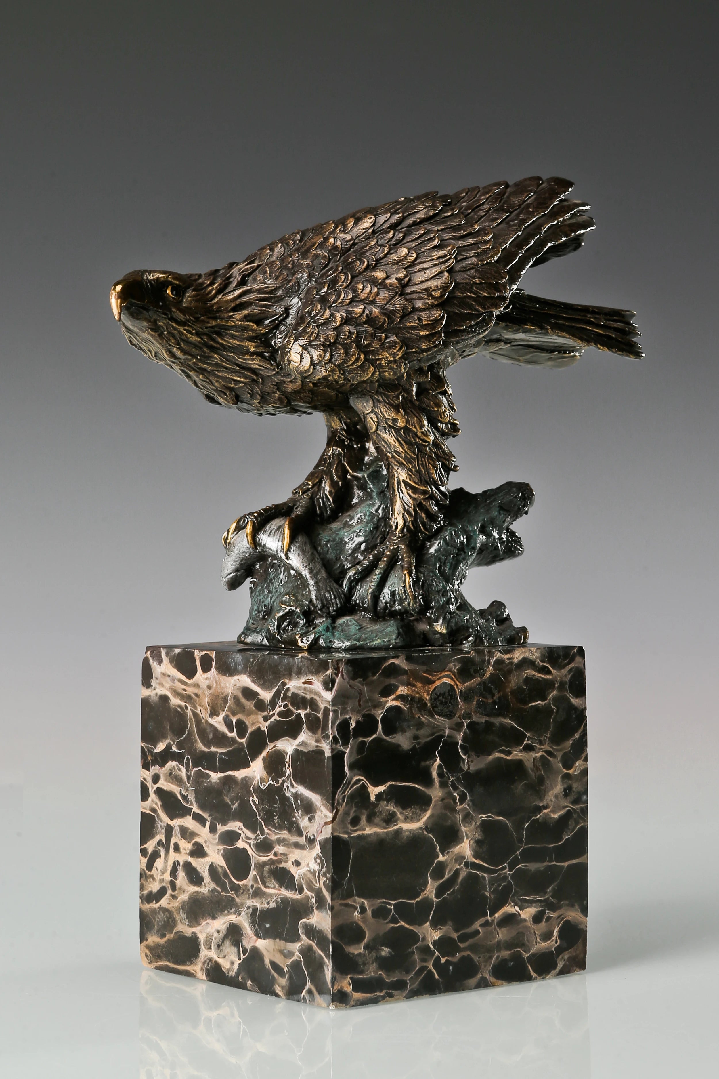 Pre-flight bronze eagle sculpture with detailed feathers and natural base. Elegant wildlife statue for home decor, office, or collectors.