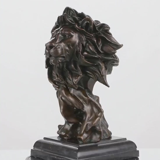 This is a powerful bronze bust of a lion, crafted using the lost-wax casting method. The sculpture focuses on the lion’s head and upper neck, capturing the animal in a moment of intense focus and regal authority. 