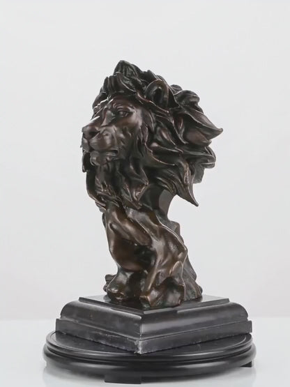 This is a powerful bronze bust of a lion, crafted using the lost-wax casting method. The sculpture focuses on the lion’s head and upper neck, capturing the animal in a moment of intense focus and regal authority. 