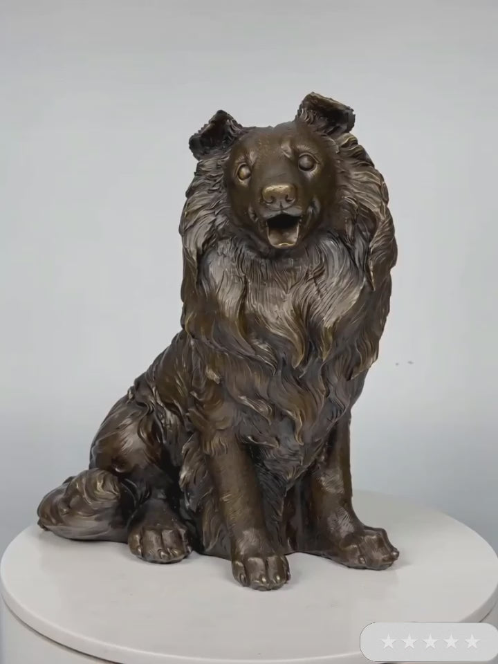 This is a lifelike bronze sculpture of a collie dog, crafted using the lost-wax casting method. The piece captures the dog in a seated pose, with its mouth open in a friendly, alert expression, conveying warmth and intelligence. The rich, warm bronze patina accentuates the intricate, flowing texture of its long, wavy coat, which cascades down its neck and body in detailed, lifelike folds.