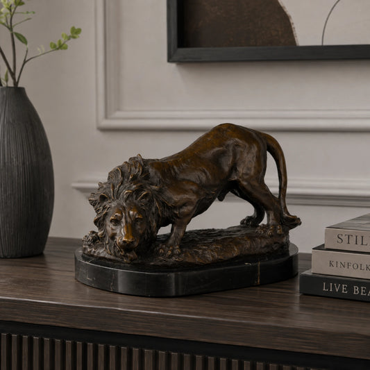 Prowling bronze lion sculpture displayed as powerful executive office and luxury home decor