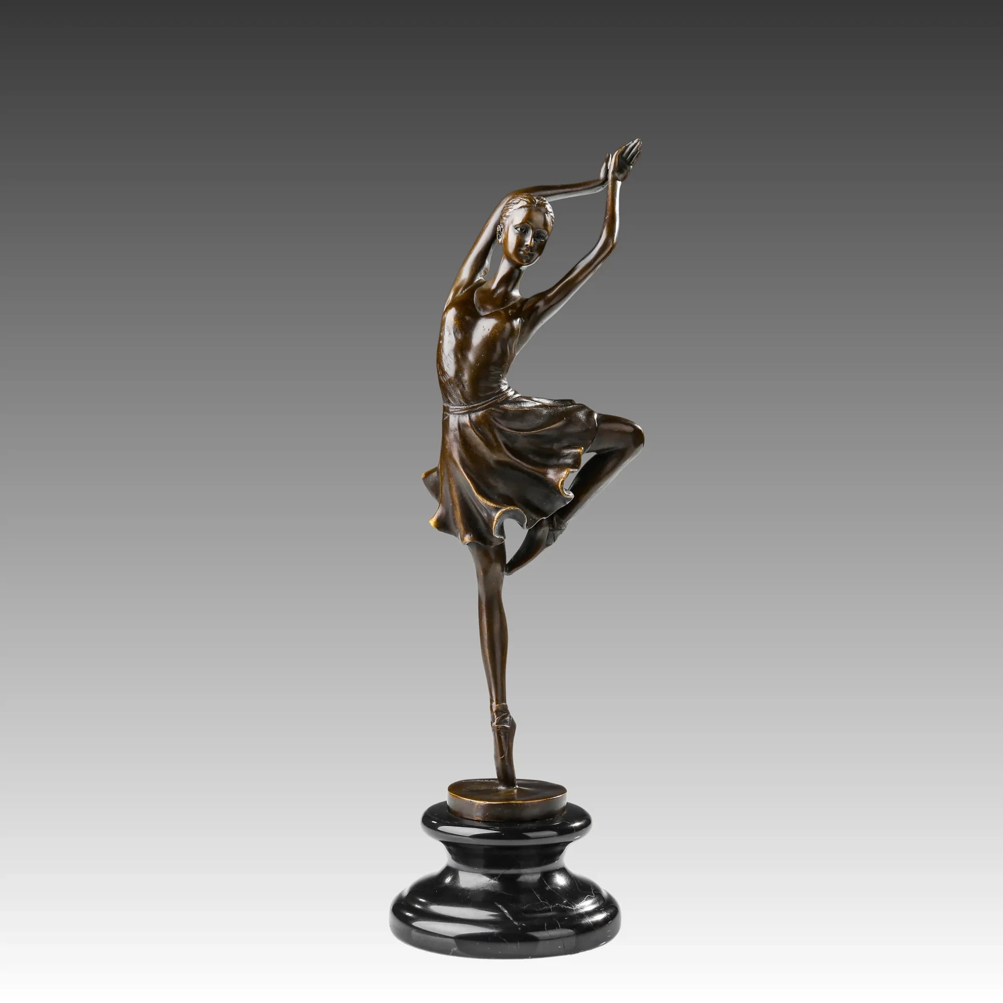 Raised leg ballerina bronze sculpture standing en pointe with arms overhead