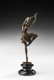 Raised leg ballerina bronze sculpture standing en pointe with arms overhead