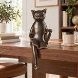 Reading cat bronze sculpture displayed with books in a stylish home library