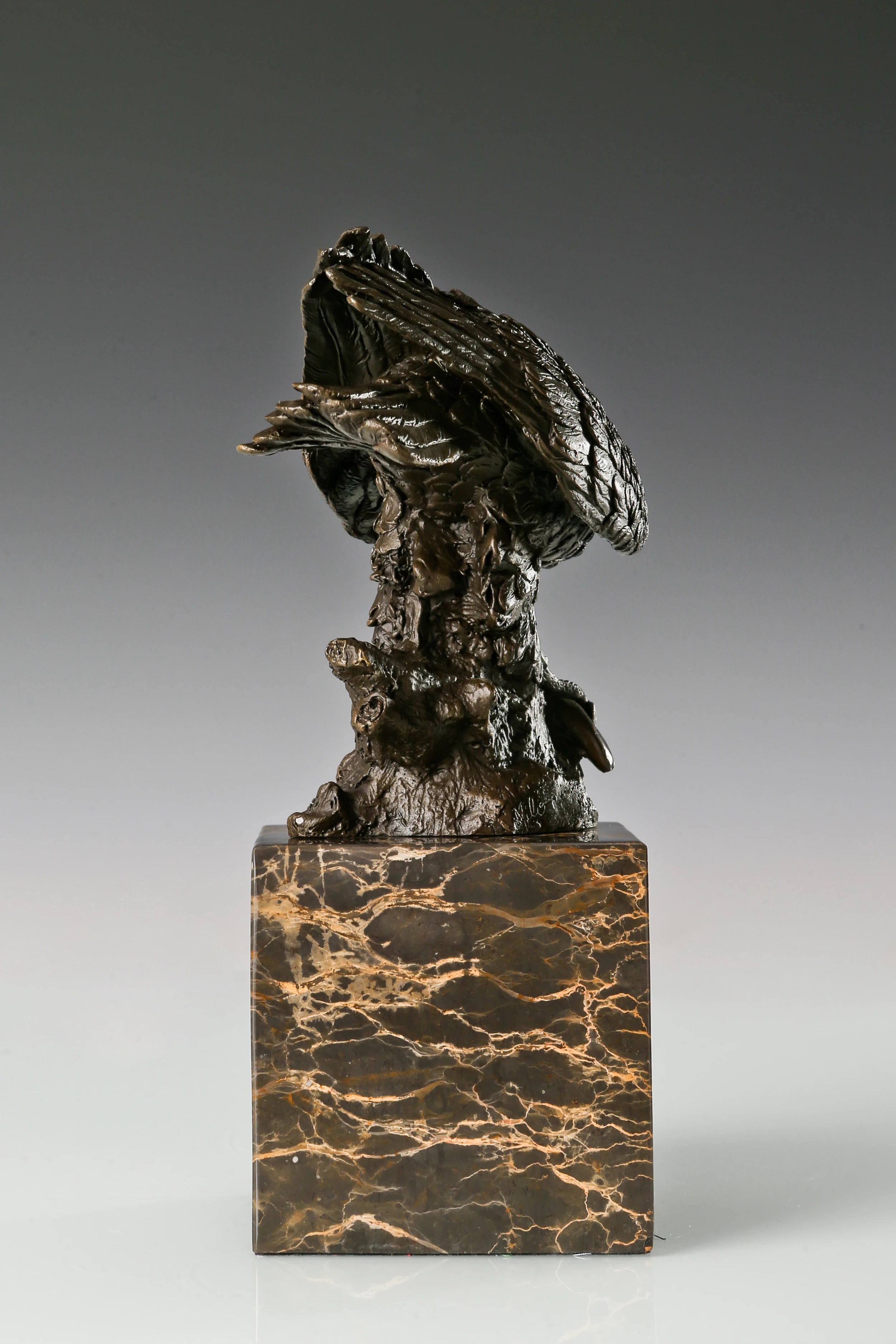 Pre-flight bronze eagle sculpture with detailed feathers and natural base. Elegant wildlife statue for home decor, office, or collectors.