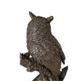 Rear view of realistic bronze owl sculpture showing layered wing and feather details