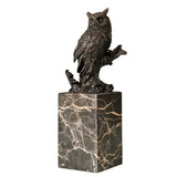 Left side view of realistic bronze owl sculpture with detailed wings and branch base