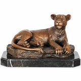 Bronze resting lioness statue with warm patina displayed as elegant office and home decor