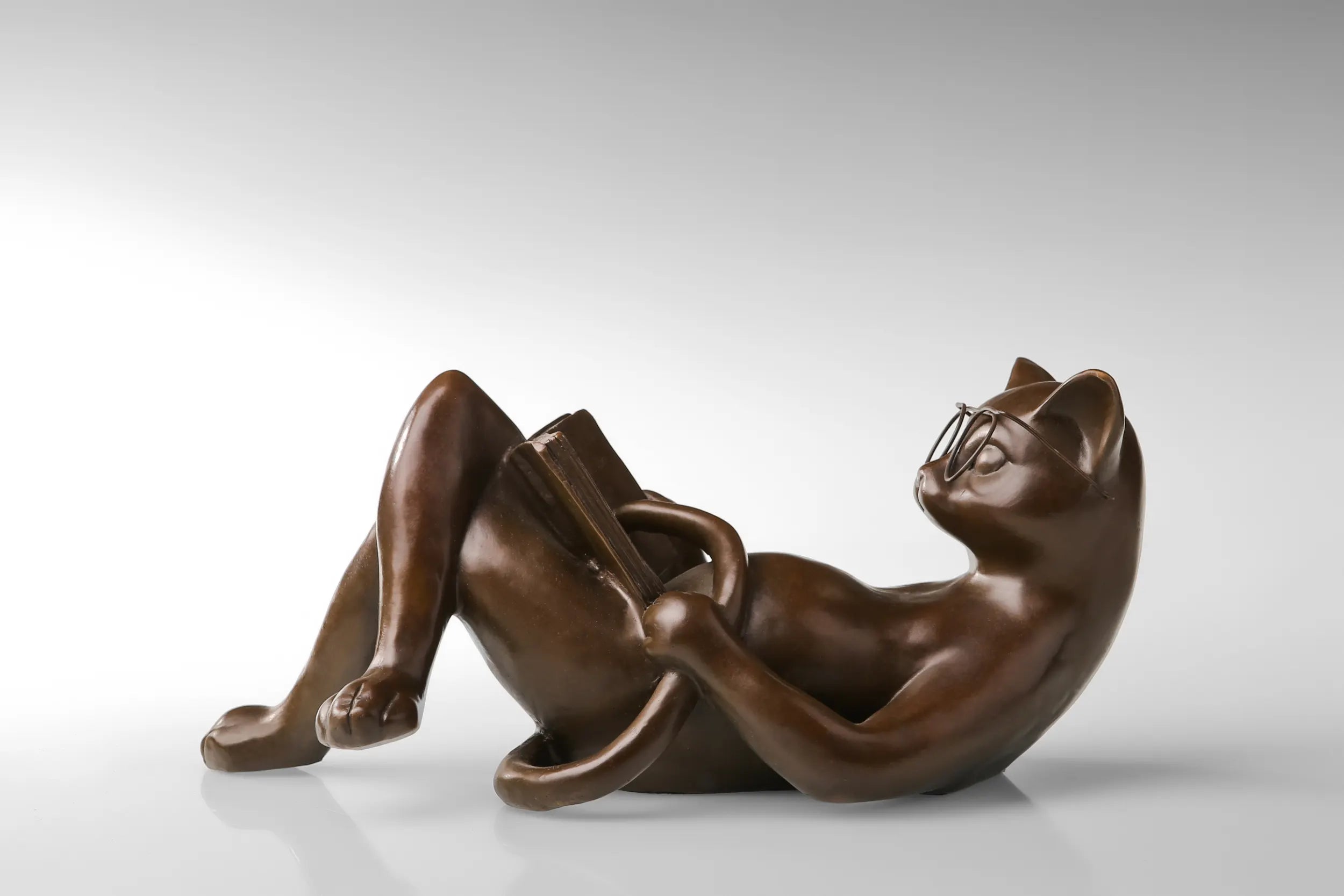 Reclining Reading Cat bronze sculpture side view