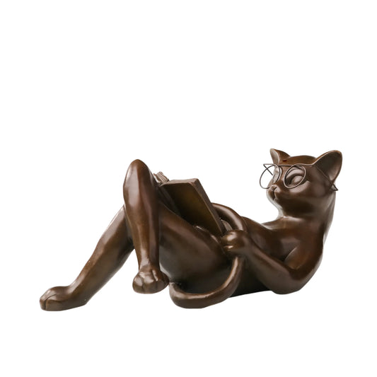Reclining reading cat bronze sculpture wearing glasses and holding a book