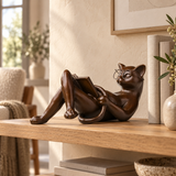 Reclining Reading Cat bronze sculpture displayed in a minimalist interior