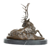 Left side view of resting stag bronze statue on marble base
