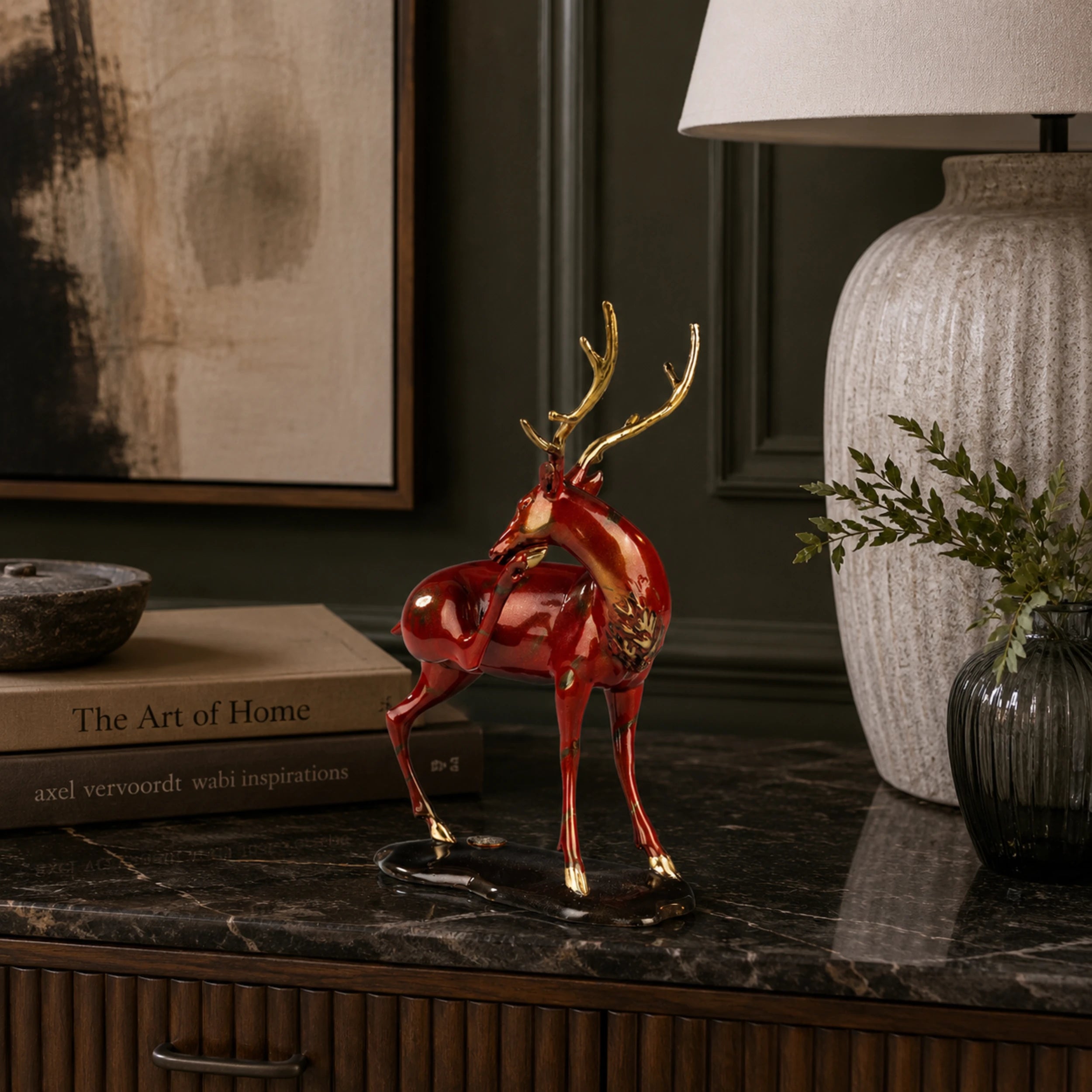 Red bronze reindeer sculpture displayed as elegant Christmas mantel and holiday home decor