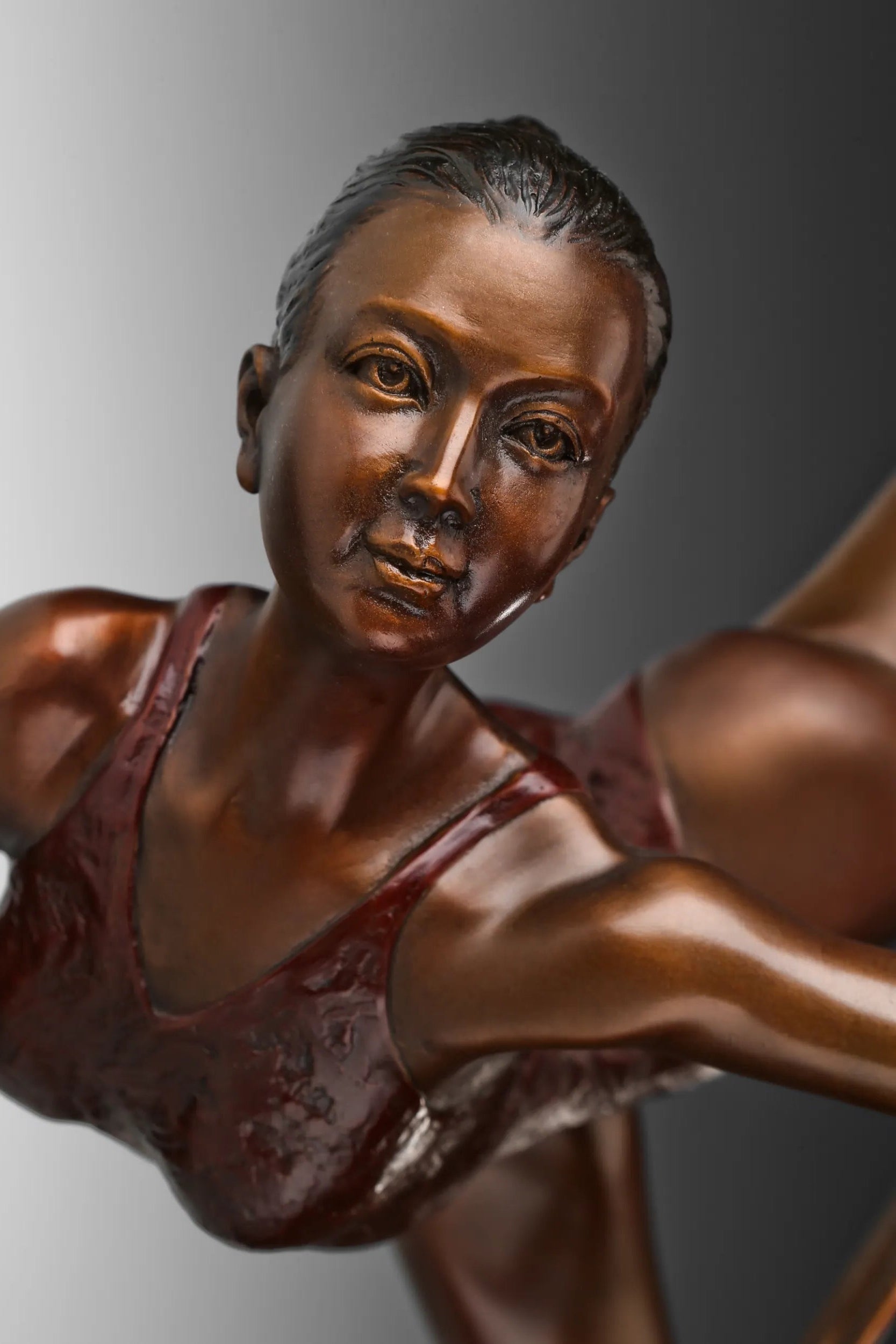 Close-up of female ballet ribbon dancer bronze sculpture showing her facial expression