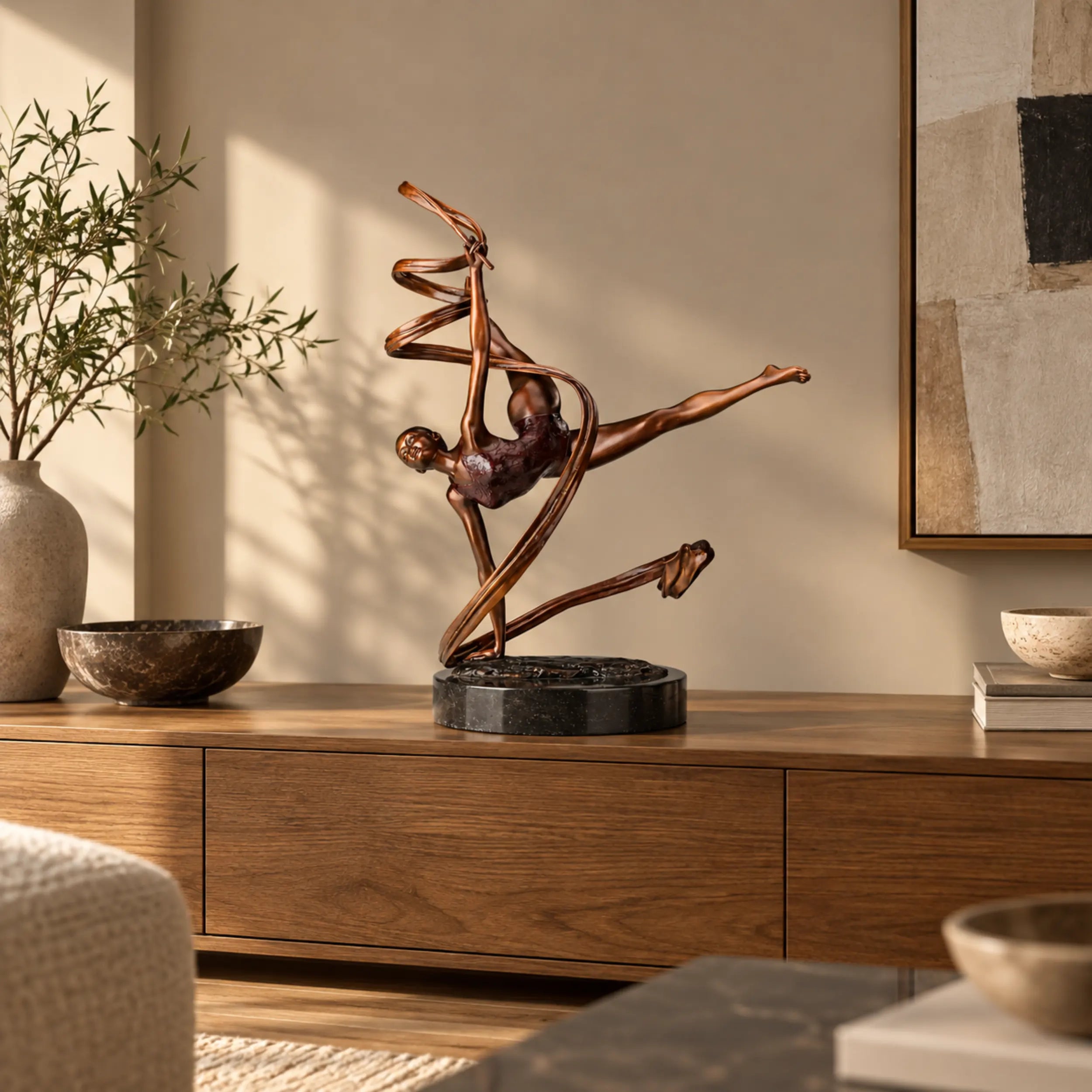 Ribbon ballet dancer bronze sculpture displayed on a wooden console in a warm modern living room