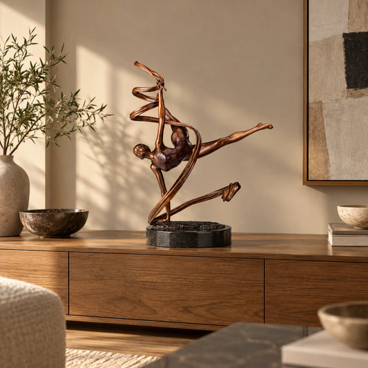 Ribbon ballet dancer bronze sculpture displayed on a wooden console in a warm modern living room