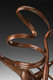 Close-up of the spiraling bronze ribbon ballet with smooth sculpted curves