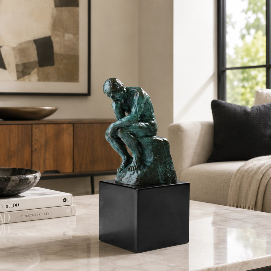 Rodin-inspired The Thinker bronze sculpture displayed in a modern interior