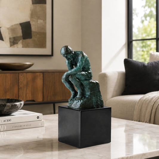 Rodin-inspired bronze Thinker sculpture with verdigris patina on a black marble base