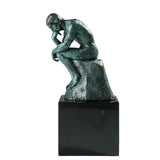 Left side view of the classical Thinker bronze sculpture with verdigris patina