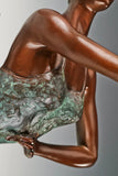 Extended arm and arched upper body of the artistic roller skater bronze sculpture