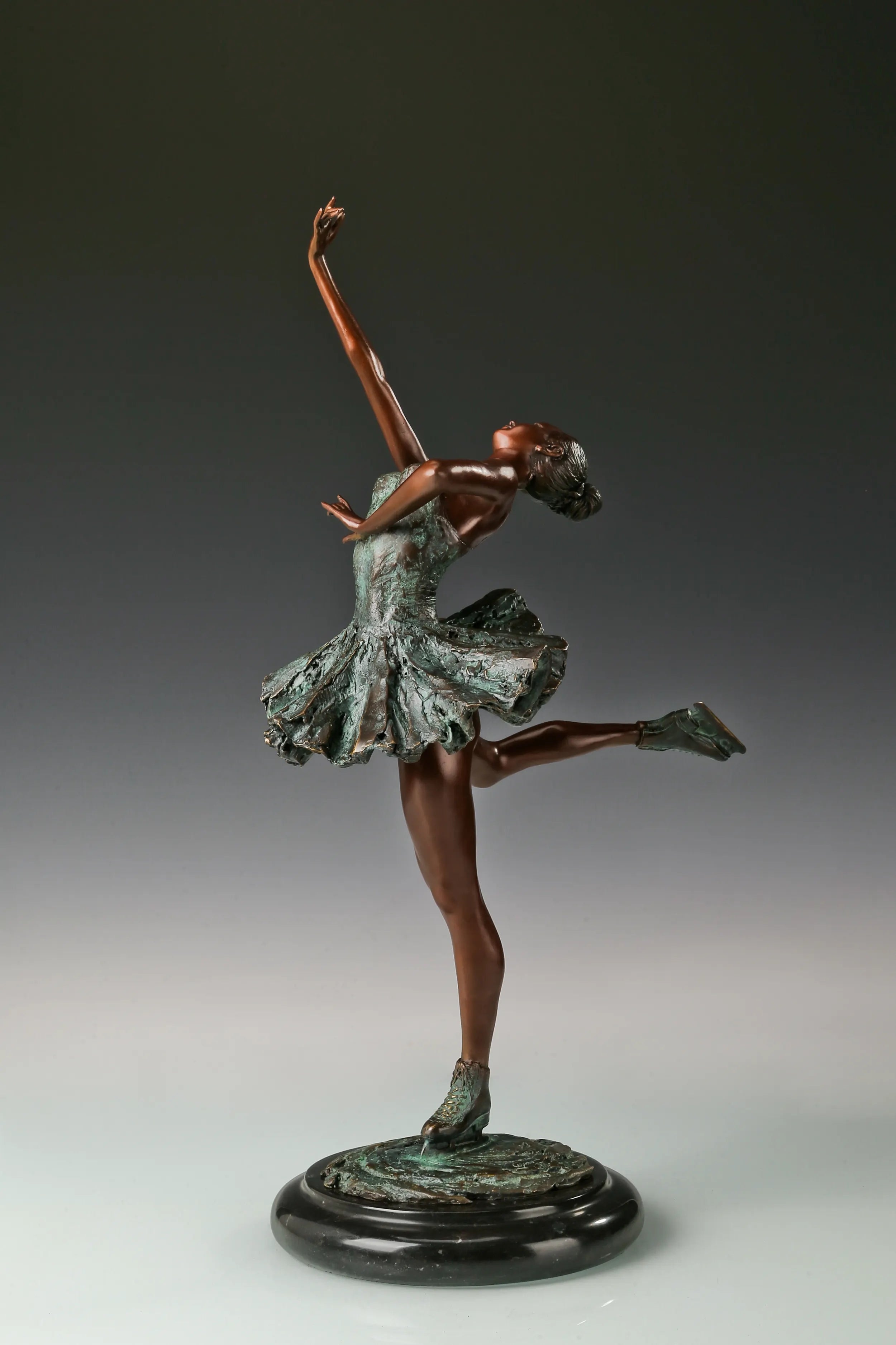 Left side view of roller skating ballerina bronze sculpture with one leg lifted behind