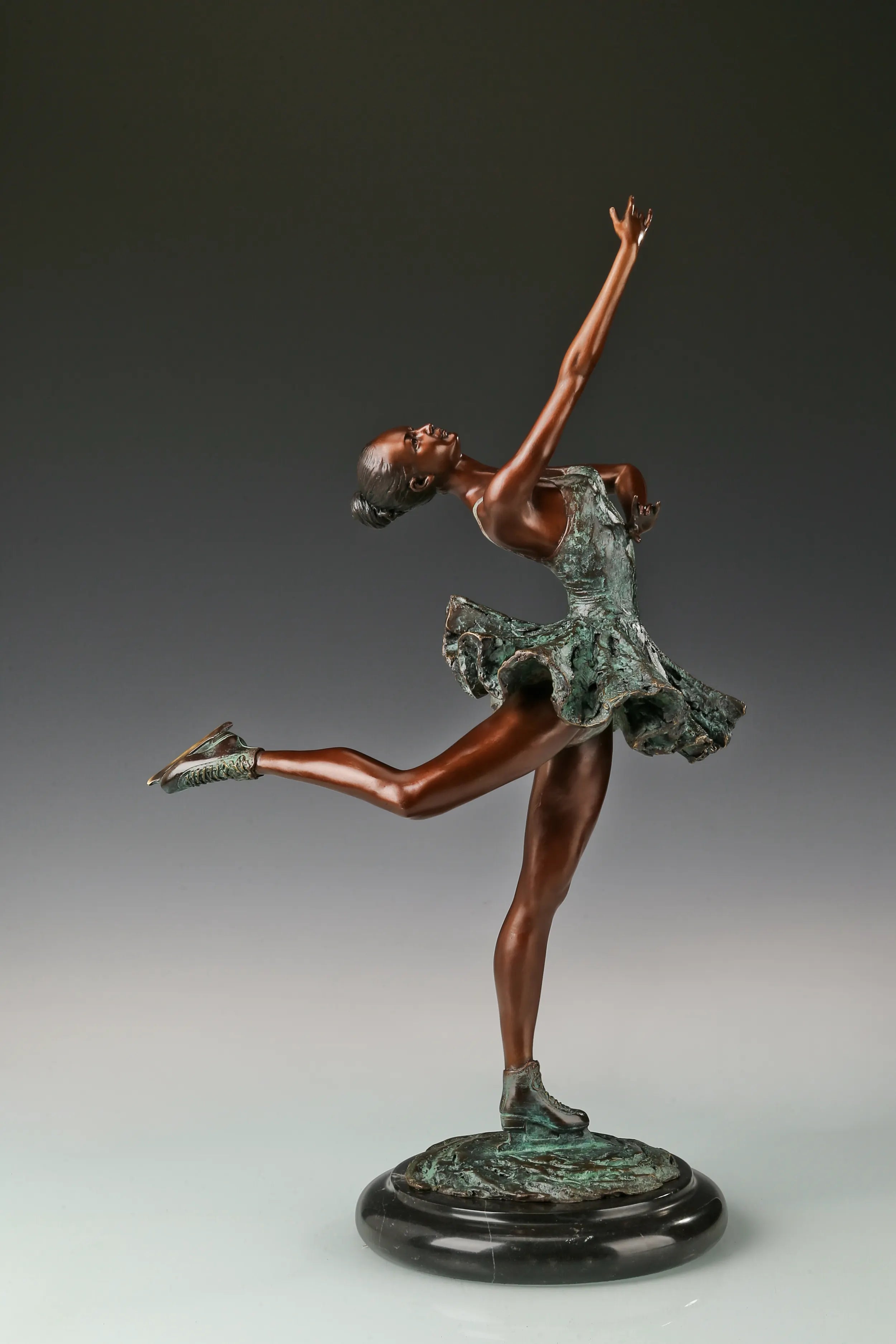 Right side view of bronze roller skater statue in an elegant balancing pose