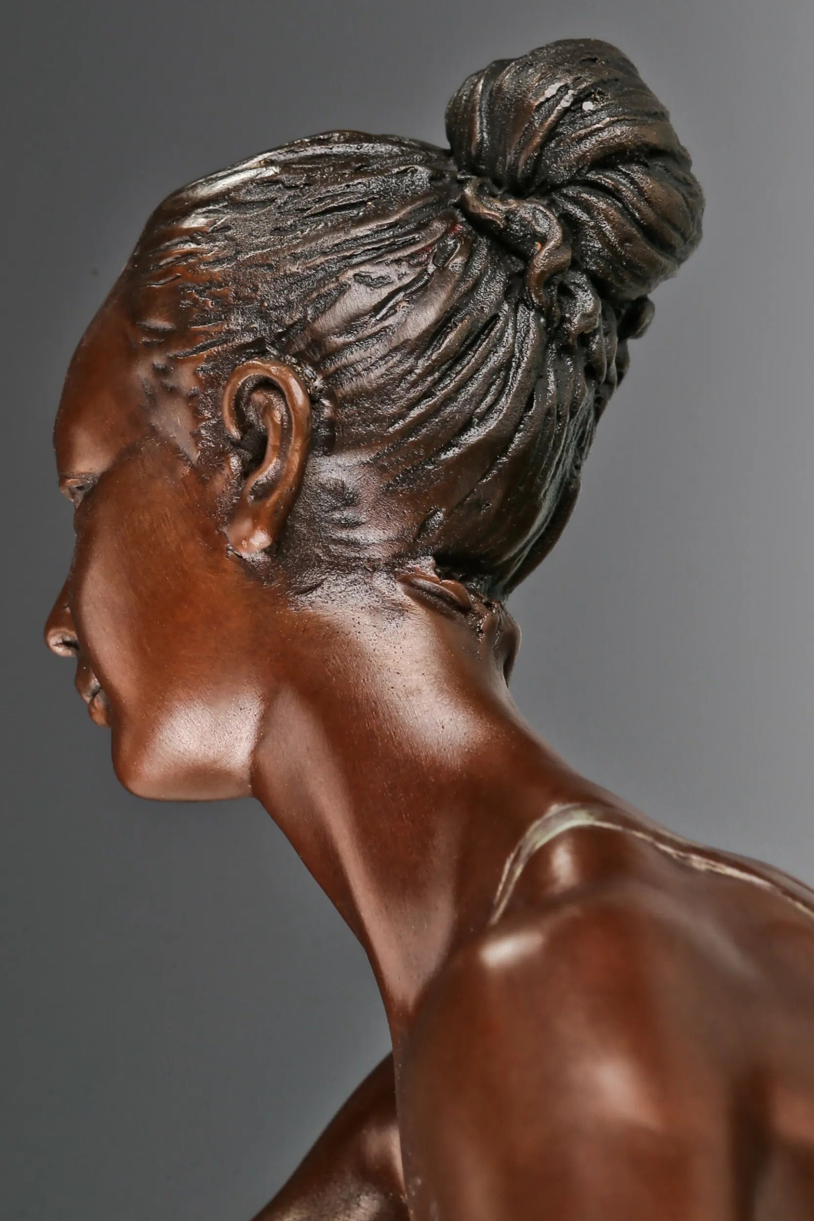 Close-up of bronze roller skating ballerina showing her upward gaze and sculpted hairstyle
