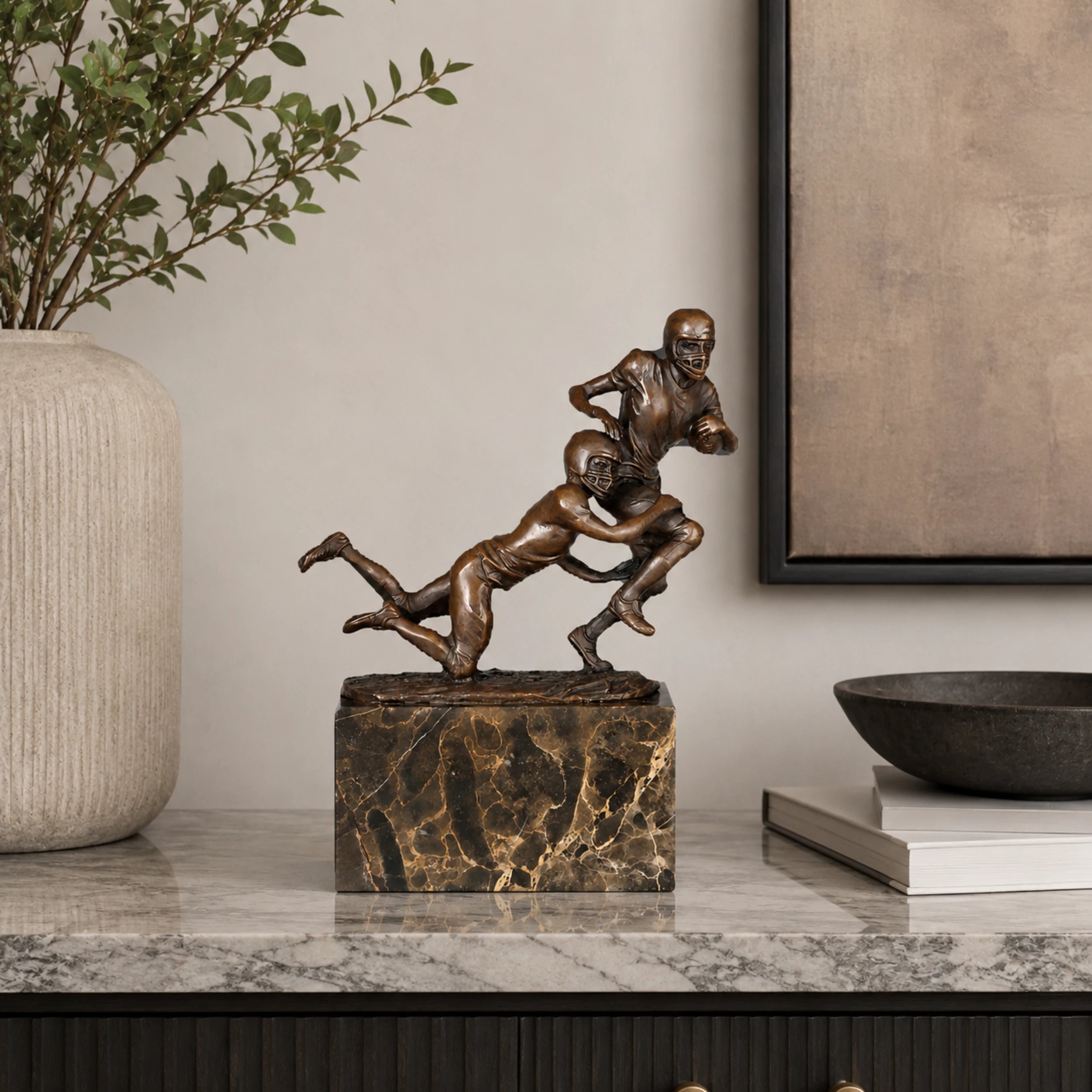 Rugby Tackle Bronze Sculpture displayed in a modern interior