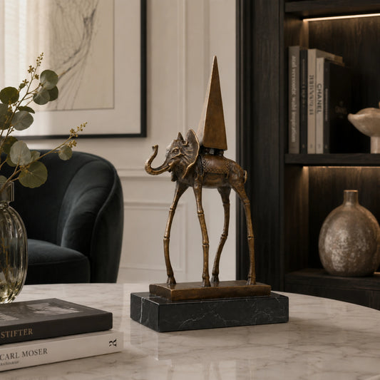 A surrealist bronze elephant on stilts sculpture with an obelisk on its back, mounted on a black marble base for modern art decor.